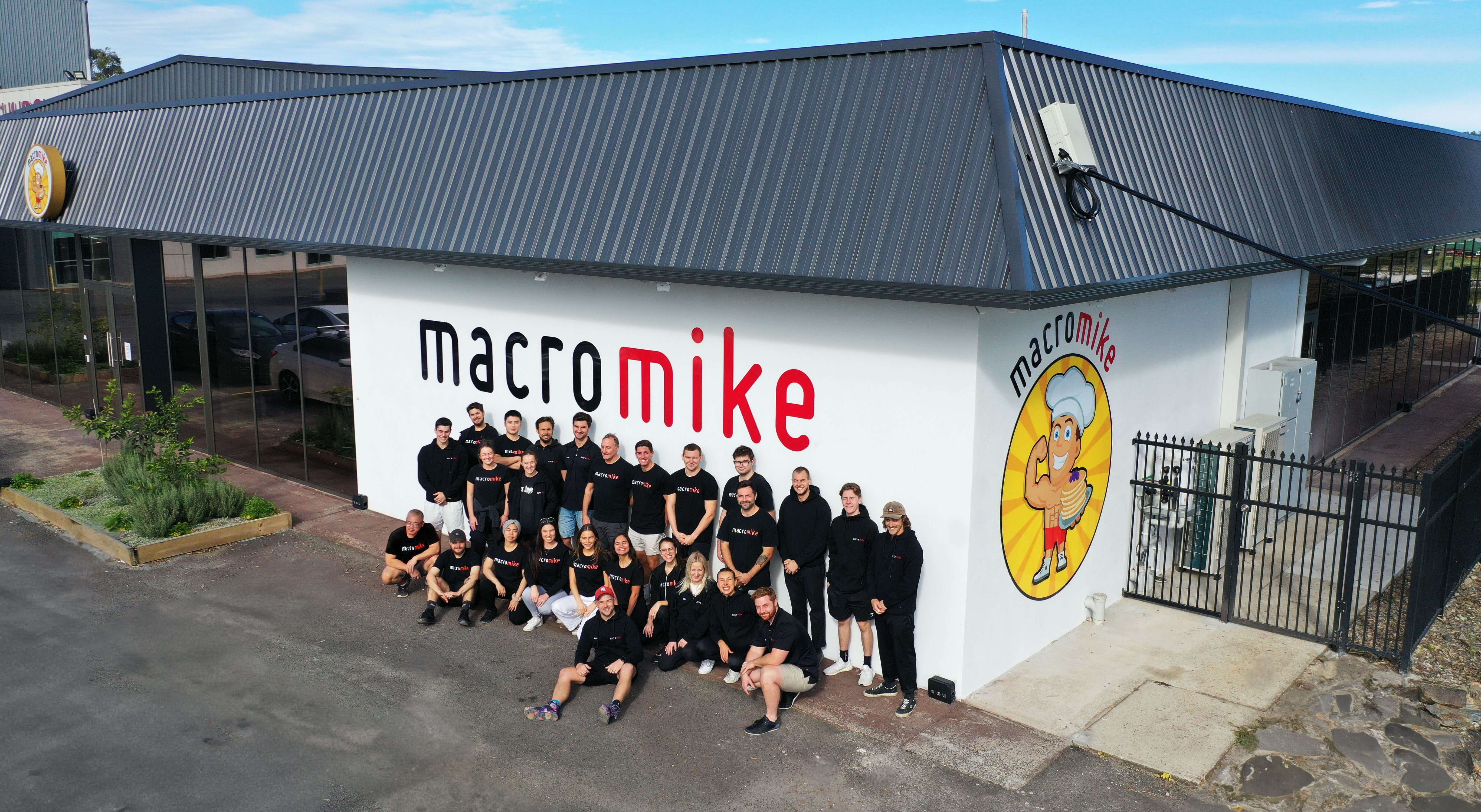 Macro Mike employees standing outside of the building. Photo taken on a drone camera from above.
