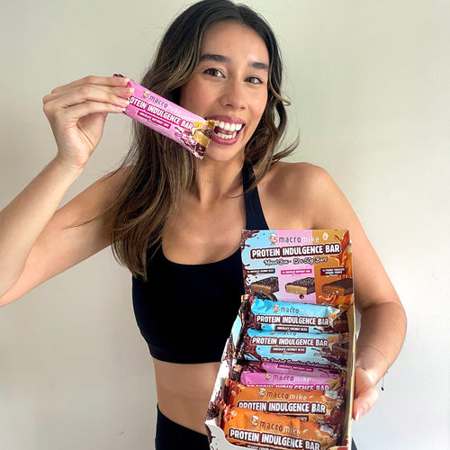 Woman holding protein bars in a box